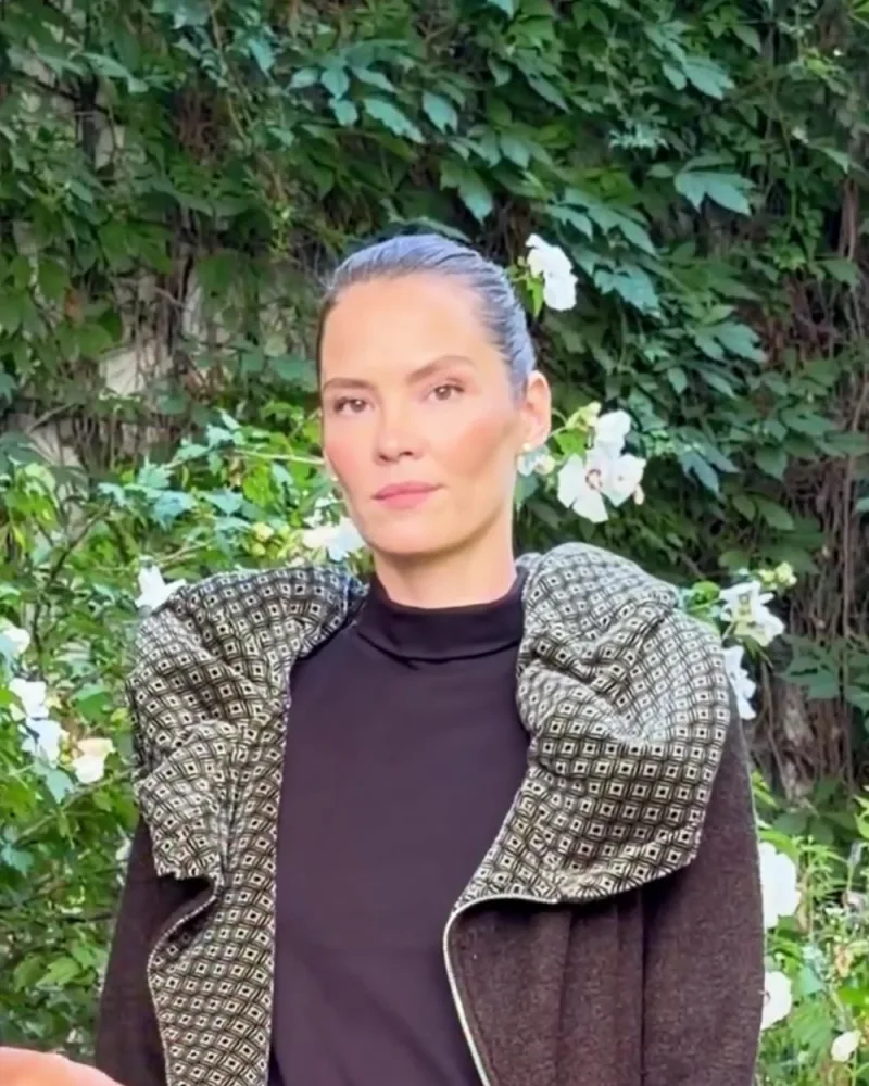 Elisabeth trägt den Mantel Norina offen, innen sieht man den gemusterten Samt an Kragen und Vorderkante