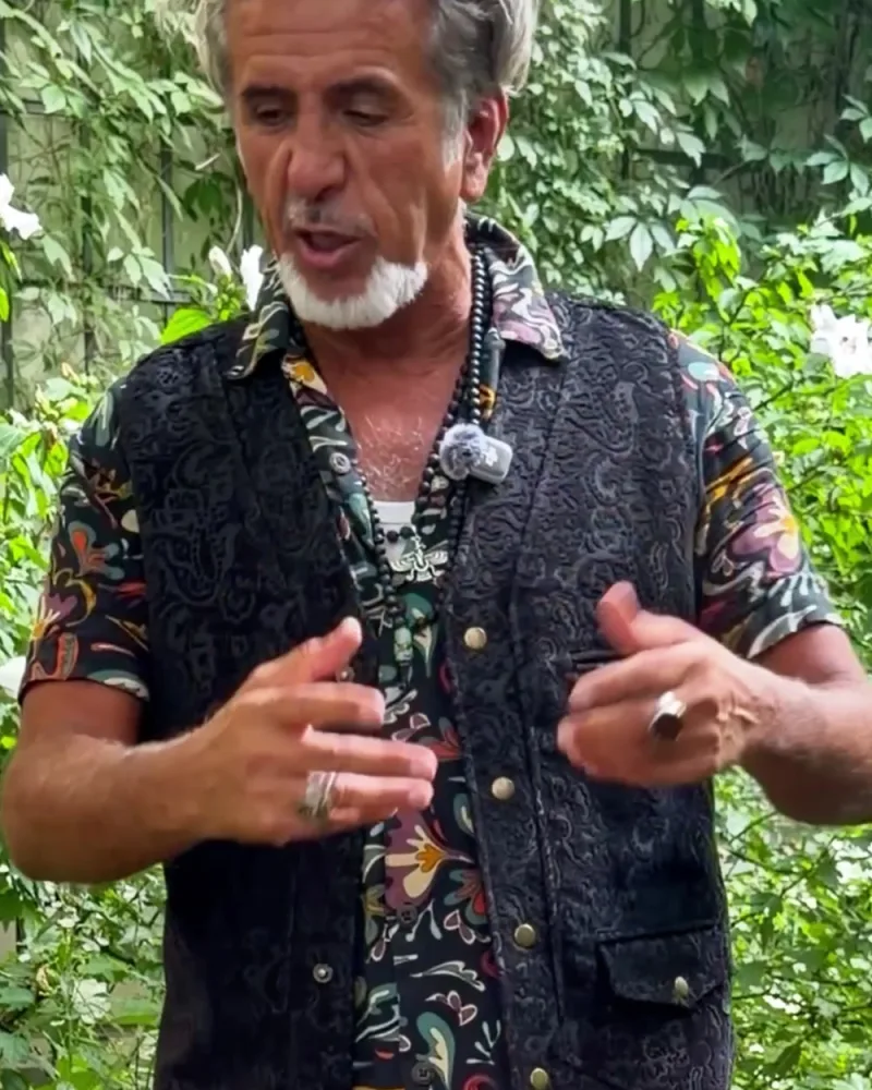 Hamid zeigt die Taschen der Weste Wolf